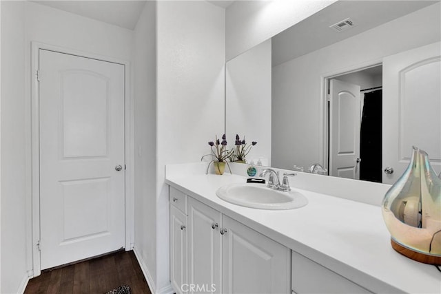 bathroom with vanity and wood-type flooring