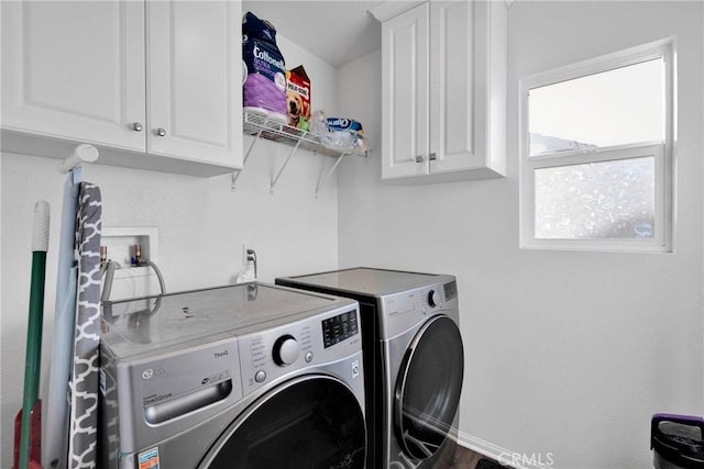 laundry room with cabinets and separate washer and dryer