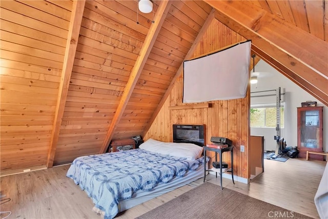 bedroom with vaulted ceiling with beams, wooden ceiling, wooden walls, and light wood-type flooring