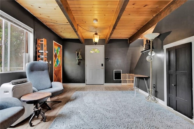 sitting room with beam ceiling, wood ceiling, and light hardwood / wood-style flooring