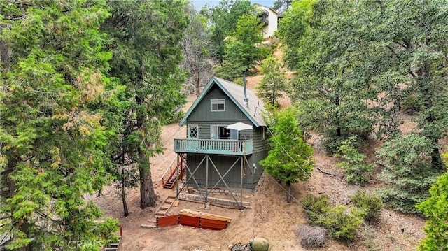 rear view of house featuring a wooden deck