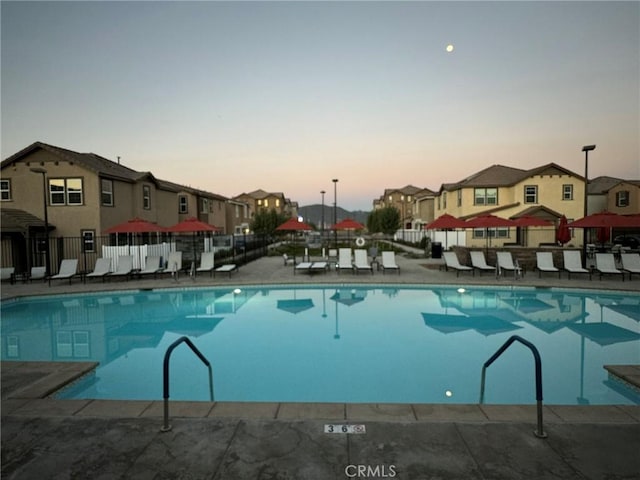 view of pool at dusk