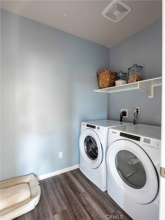 laundry area featuring dark hardwood / wood-style flooring and washing machine and dryer