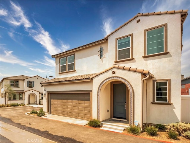 mediterranean / spanish-style home with a garage