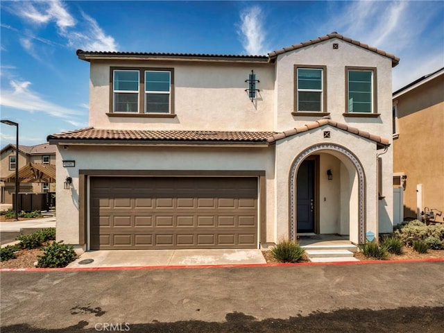 mediterranean / spanish house with a garage