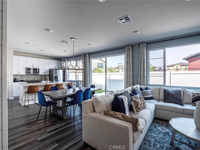 living room featuring dark hardwood / wood-style flooring and a notable chandelier