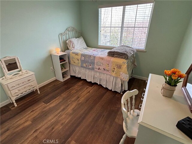 bedroom featuring dark wood-style flooring and baseboards