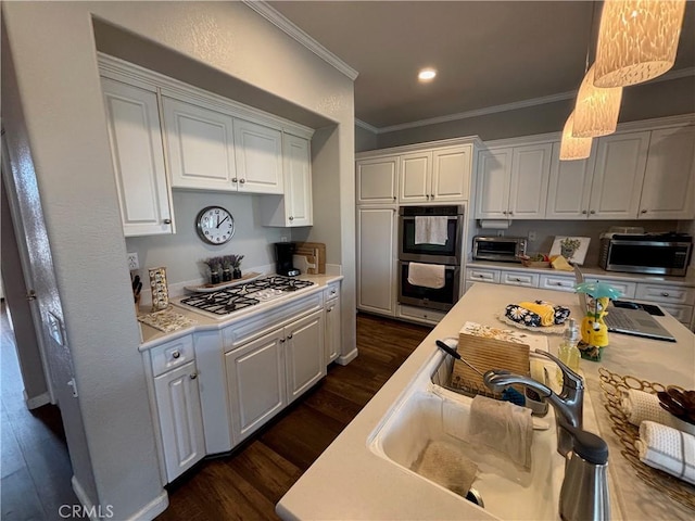 kitchen featuring white gas cooktop, light countertops, double wall oven, stainless steel microwave, and white cabinetry