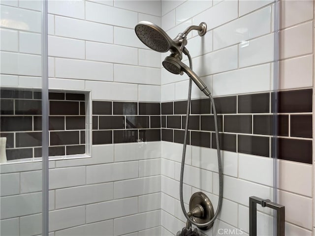 interior details featuring a tile shower