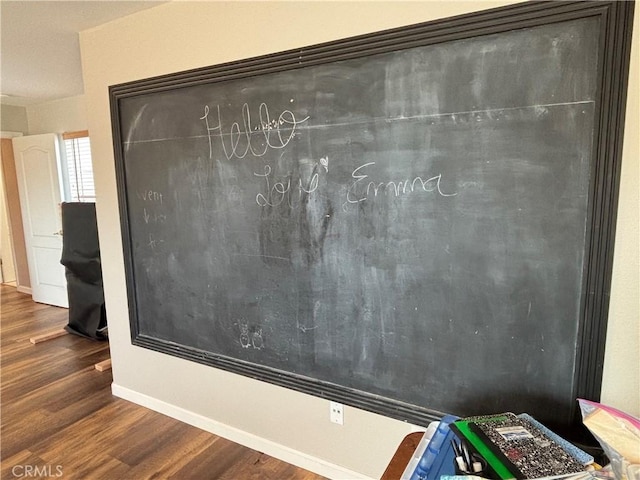 room details with baseboards and wood finished floors