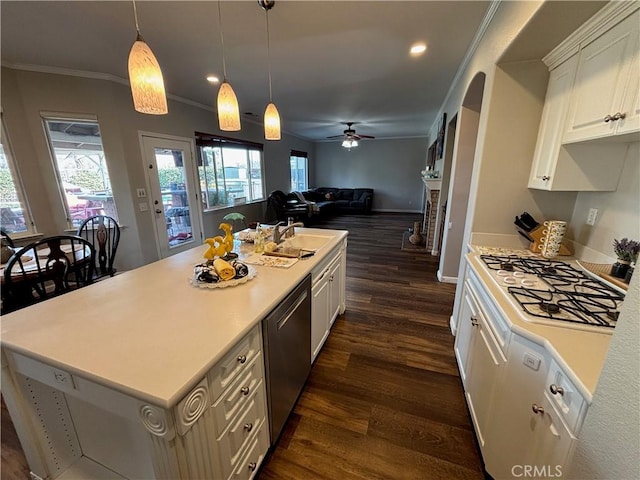kitchen featuring stainless steel dishwasher, a sink, crown molding, and dark wood-style floors