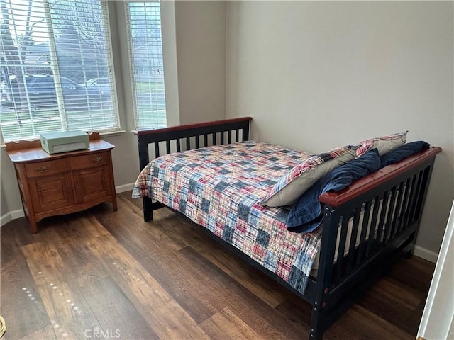 bedroom featuring baseboards and wood finished floors