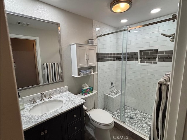 bathroom with visible vents, a stall shower, vanity, toilet, and recessed lighting