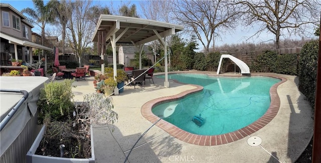 view of pool with a fenced backyard, a fenced in pool, a water slide, and a patio