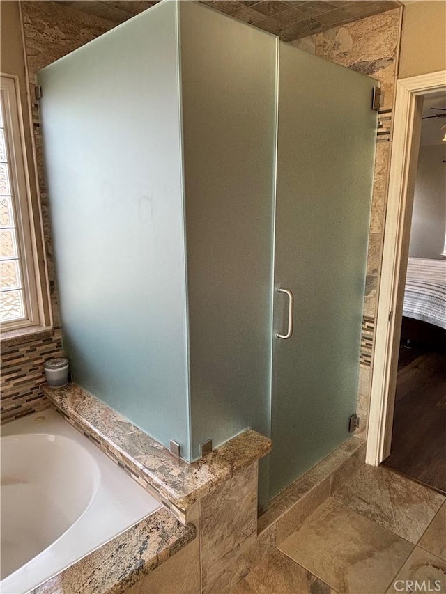 full bath with a shower stall and a garden tub