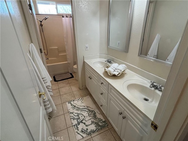 bathroom featuring a sink, tile patterned flooring, toilet, and double vanity