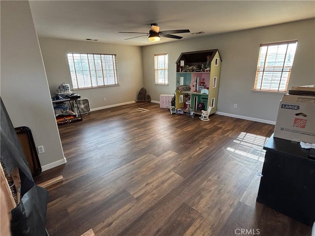misc room featuring a ceiling fan, baseboards, visible vents, and wood finished floors