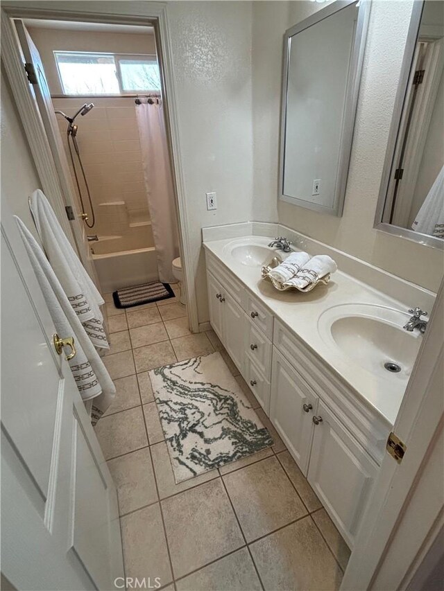 full bath featuring tile patterned flooring, a sink, and toilet
