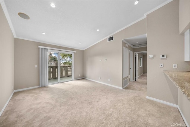 carpeted spare room featuring crown molding