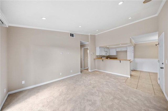 unfurnished living room featuring crown molding and light colored carpet