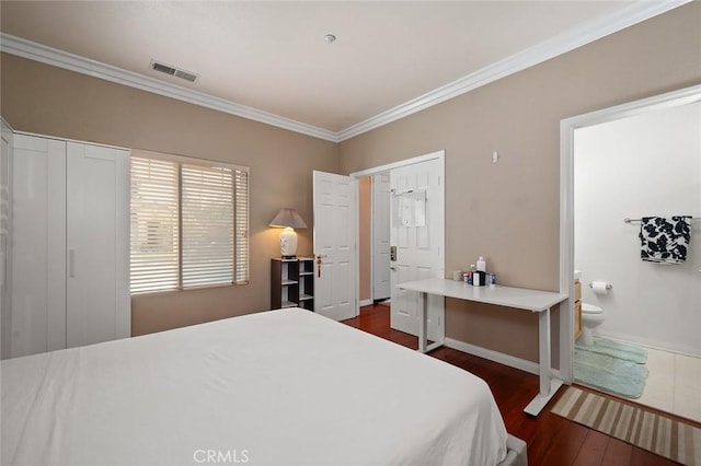 bedroom with ornamental molding, dark hardwood / wood-style floors, and connected bathroom