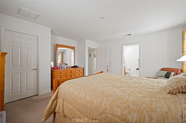 carpeted bedroom featuring ensuite bathroom