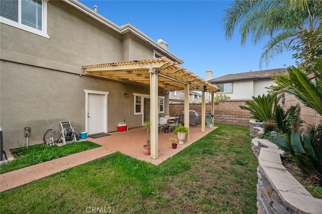 exterior space with a patio, a yard, and a pergola