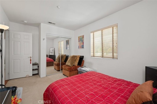 carpeted bedroom with a closet