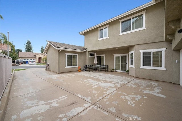 rear view of property featuring a patio area