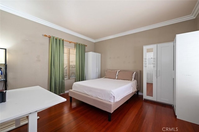 bedroom featuring crown molding and dark wood-type flooring