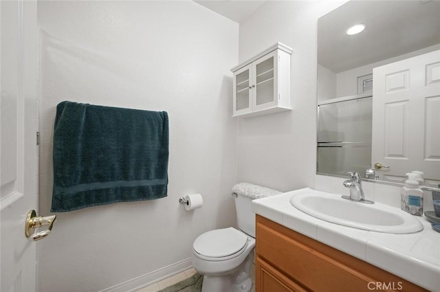 bathroom with vanity, toilet, and an enclosed shower