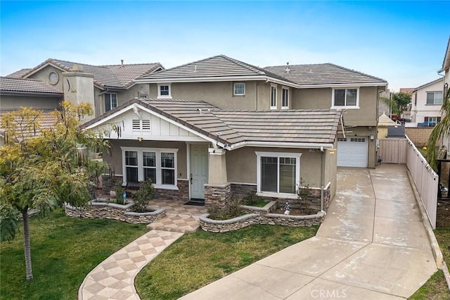 view of front of home with a garage and a front lawn