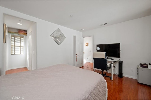 bedroom with hardwood / wood-style flooring