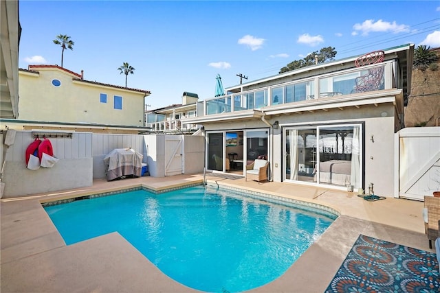 view of pool with area for grilling and a patio area