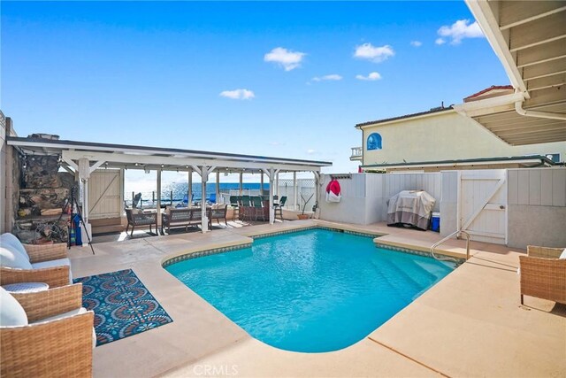 view of swimming pool with grilling area and a patio area