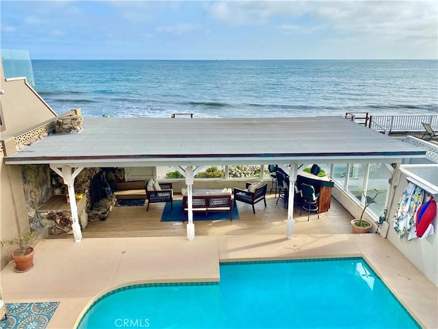 view of pool featuring an outdoor living space and a water view