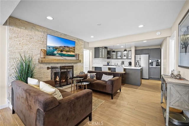 living room with a fireplace and light hardwood / wood-style floors