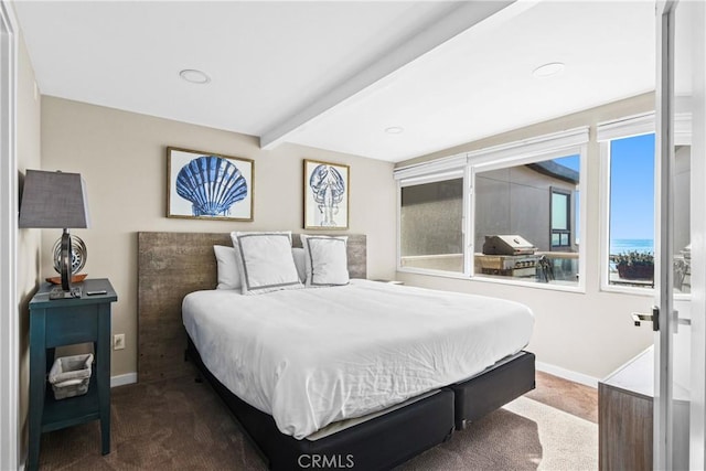 carpeted bedroom featuring beamed ceiling