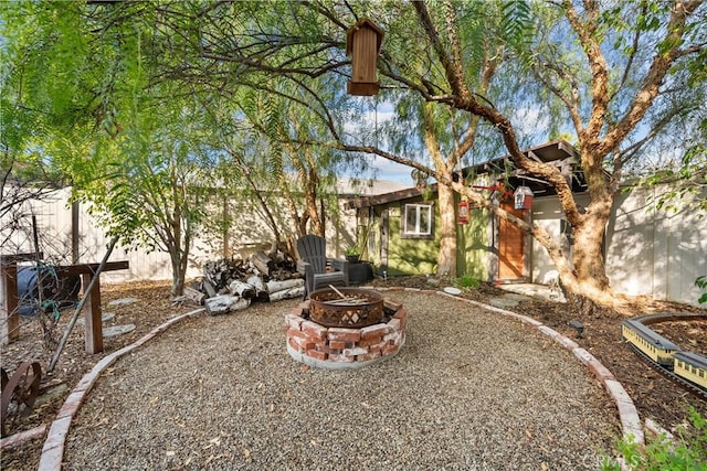 view of yard with a fire pit