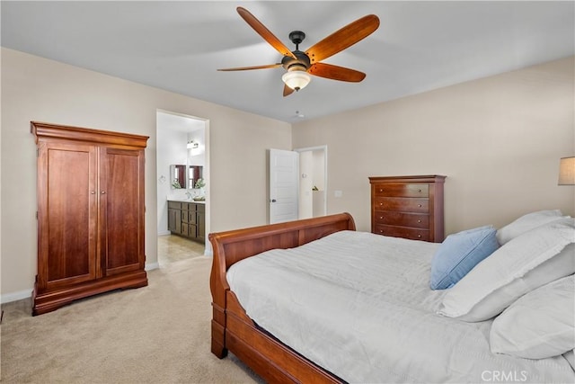 carpeted bedroom with ceiling fan and connected bathroom