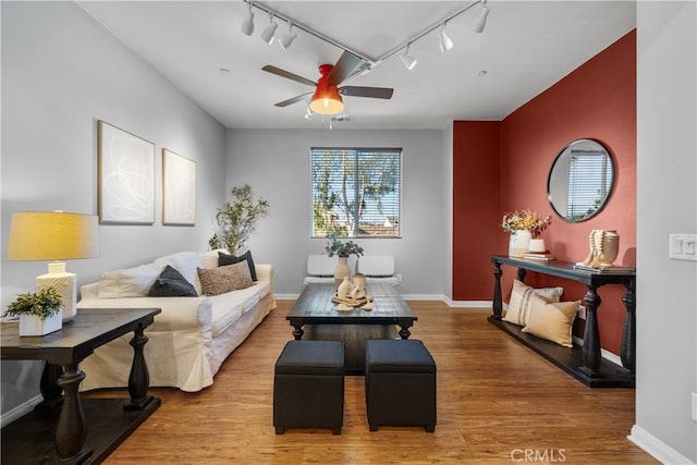 living room with hardwood / wood-style floors and ceiling fan