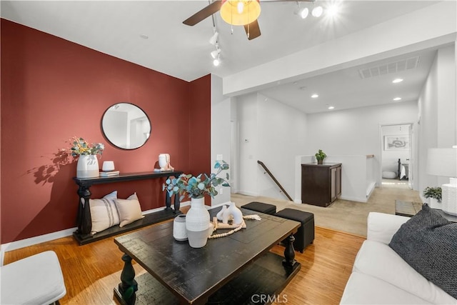 living room featuring light hardwood / wood-style flooring and rail lighting