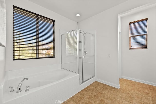 bathroom featuring tile patterned floors and shower with separate bathtub