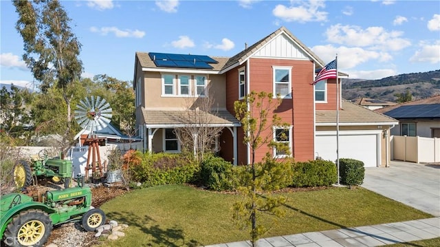 view of front of property with a front yard and solar panels