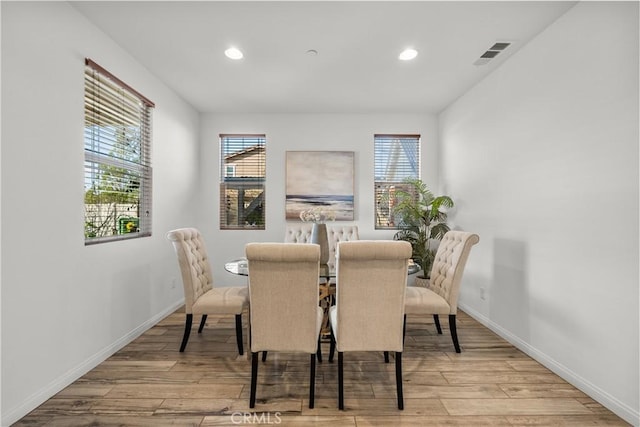 dining area with a wealth of natural light and light wood-type flooring