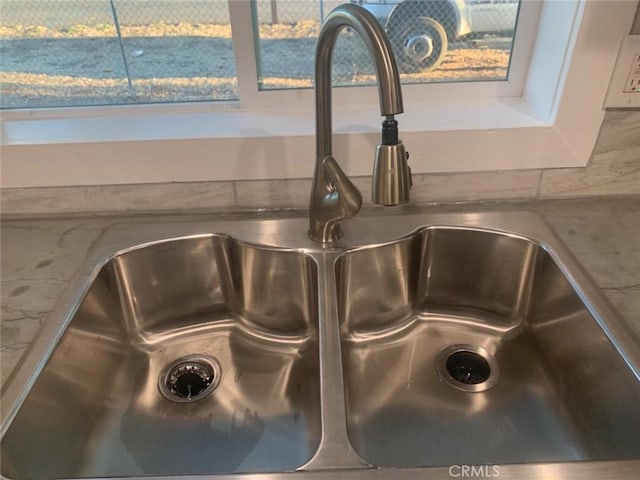 room details featuring white cabinetry and sink