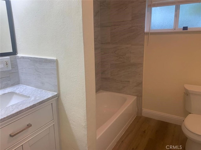 bathroom with wood-type flooring, vanity, and toilet