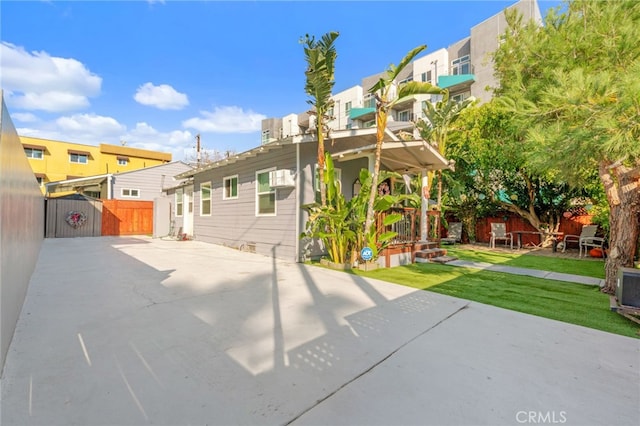 back of property featuring a yard and a patio area