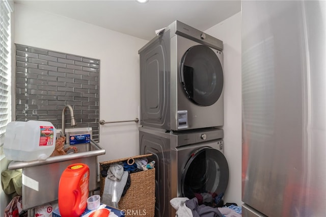 washroom featuring stacked washer / drying machine