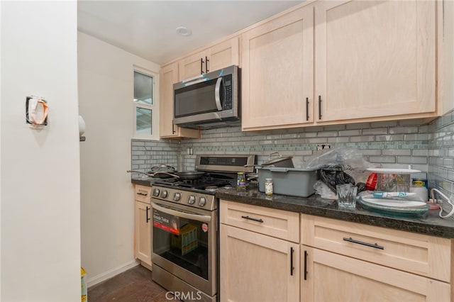 kitchen with tasteful backsplash, dark hardwood / wood-style flooring, appliances with stainless steel finishes, and light brown cabinetry